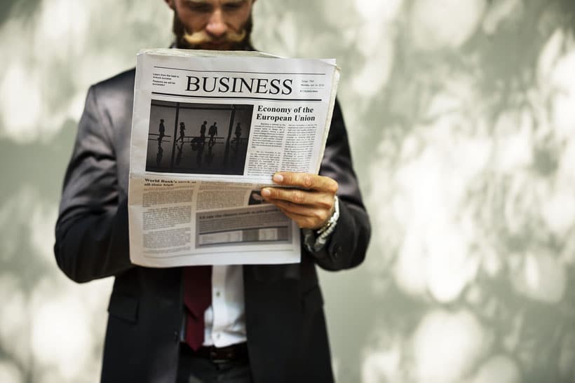 Man reading business newspaper