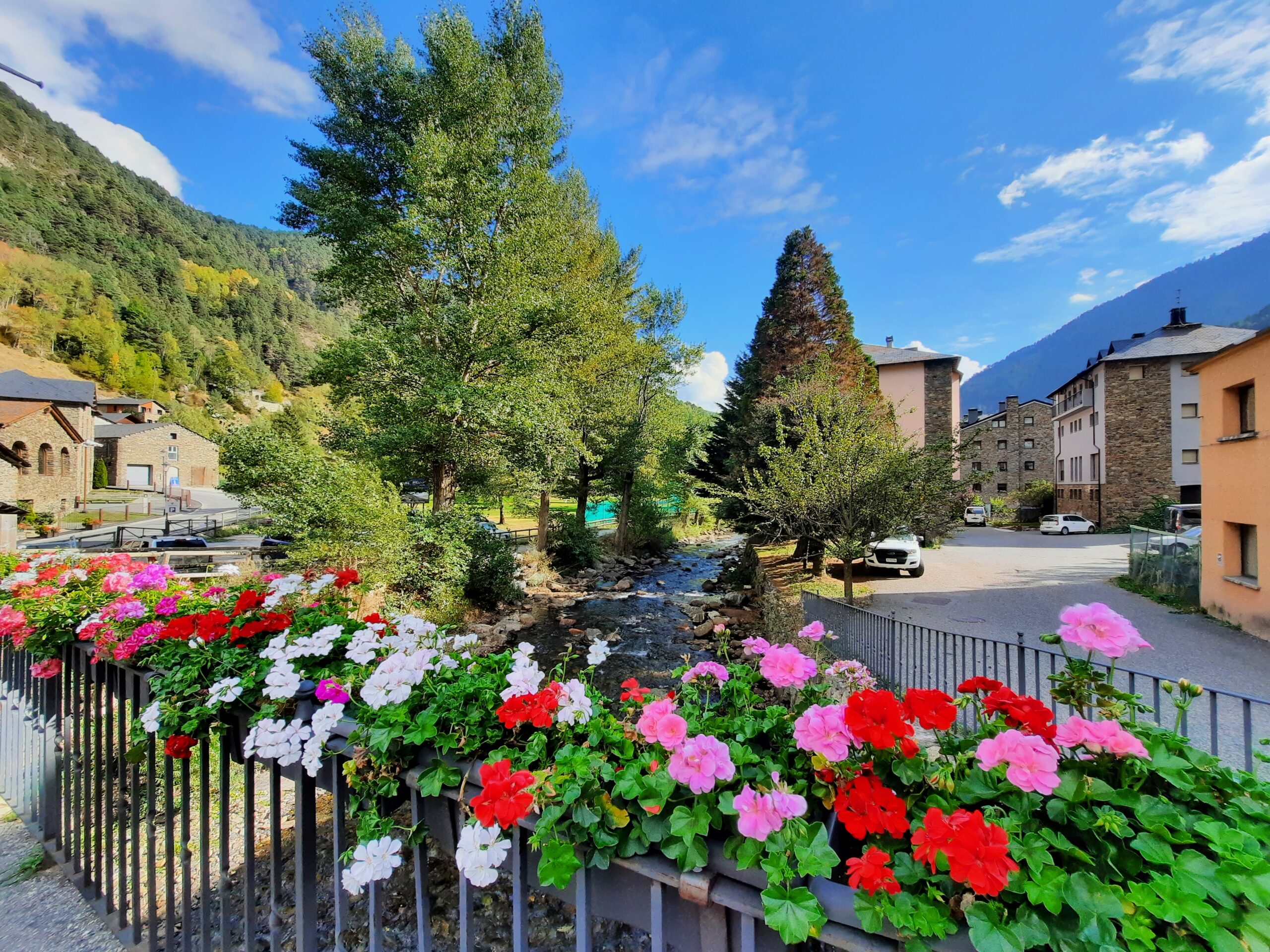 Photo of colorful flowers on a bridge in La Cortinada, Andorra.