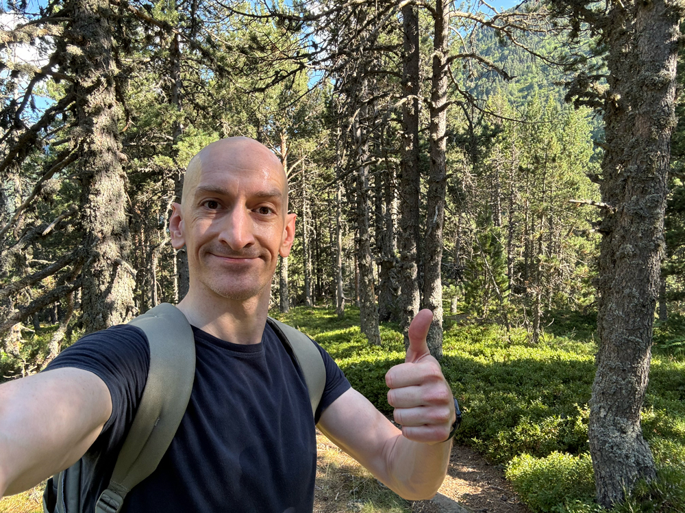 Niall Doherty in the woods giving a thumbs up