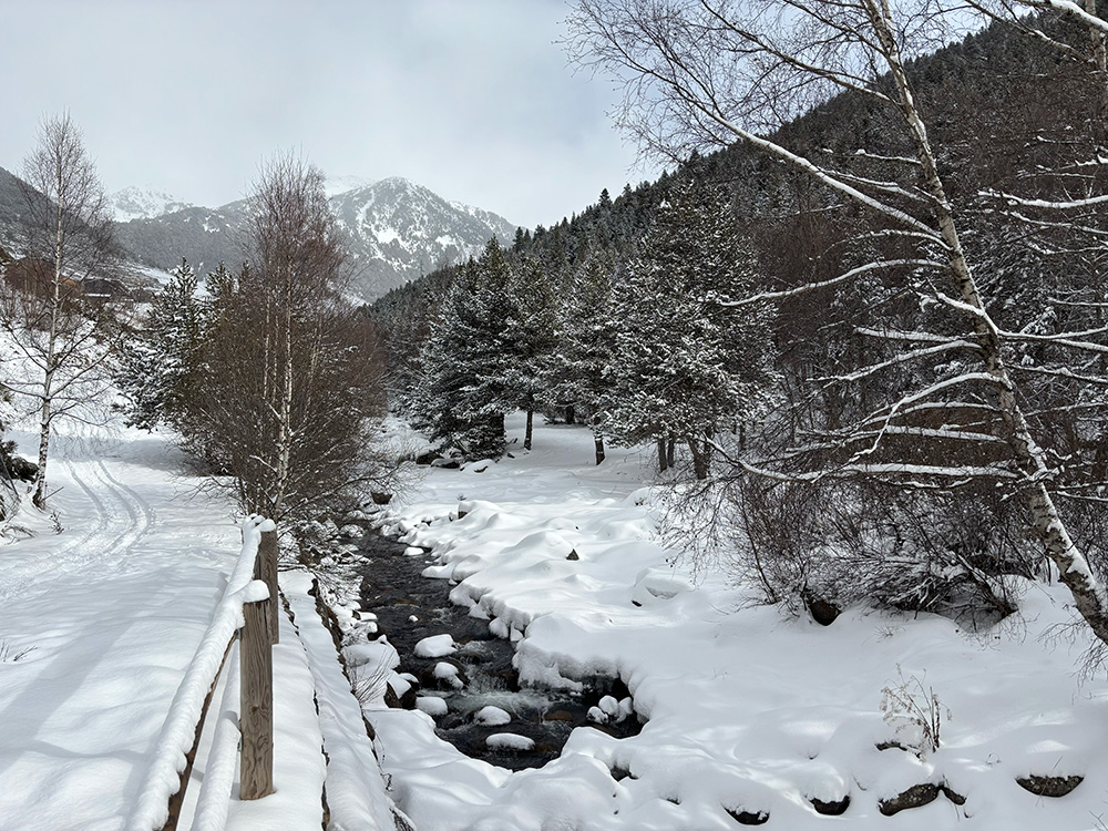 A snowy walk by the river in El Tarter, Andorra.