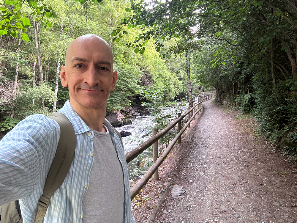 Niall Doherty walking by a river in Andorra